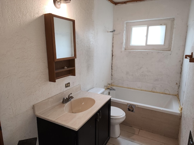 bathroom with tile patterned flooring, vanity, tiled bath, and toilet