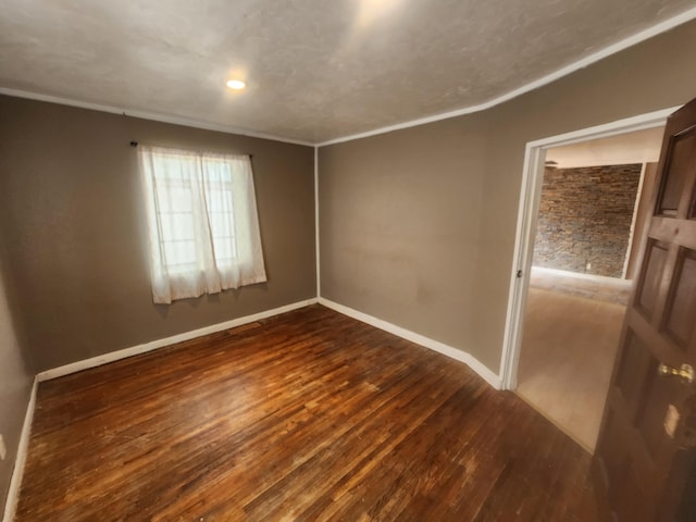 unfurnished room featuring dark hardwood / wood-style floors and crown molding