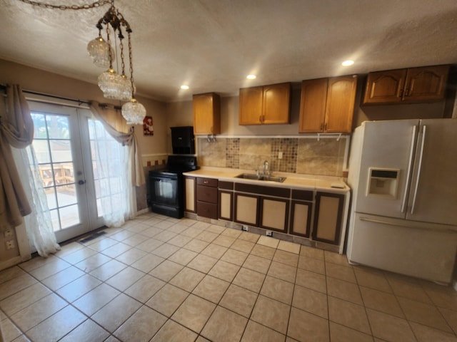 kitchen featuring black / electric stove, french doors, sink, white fridge with ice dispenser, and hanging light fixtures