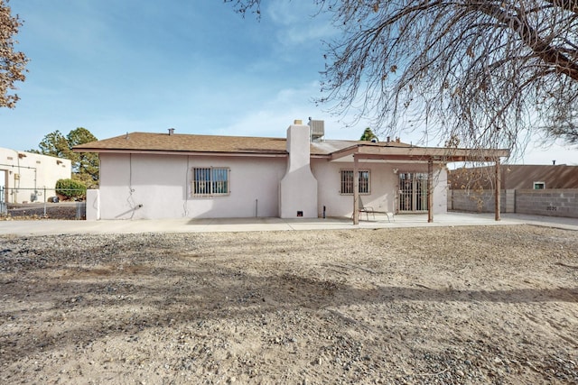 rear view of property featuring a patio area and central air condition unit