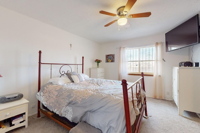 bedroom featuring ceiling fan and light carpet