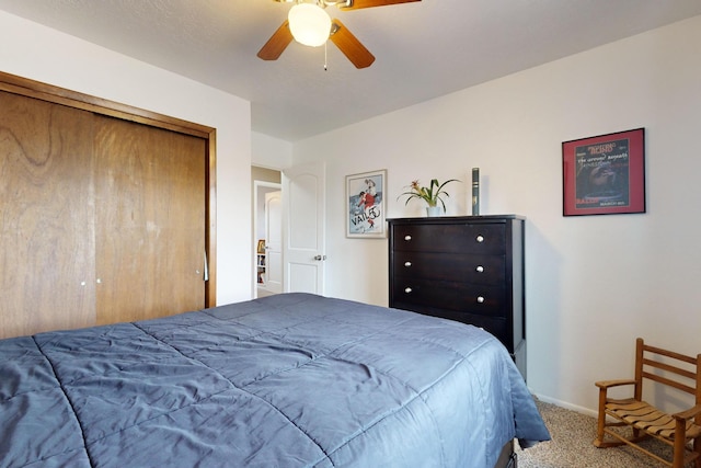 carpeted bedroom with ceiling fan and a closet