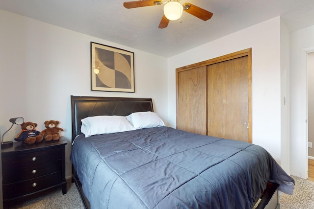 carpeted bedroom with a closet and ceiling fan