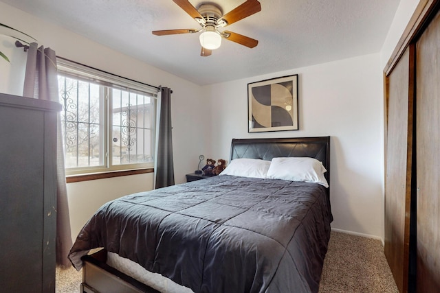 bedroom with carpet flooring, ceiling fan, and a closet