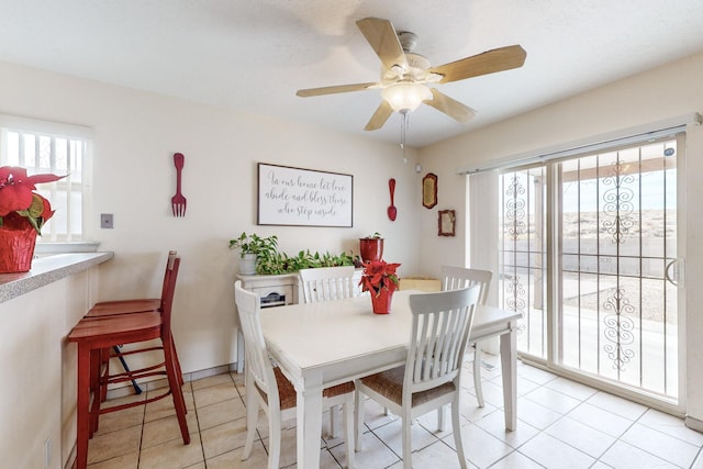 dining area featuring ceiling fan, plenty of natural light, and light tile patterned floors