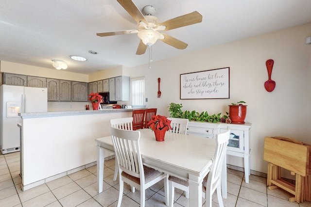 tiled dining space with ceiling fan