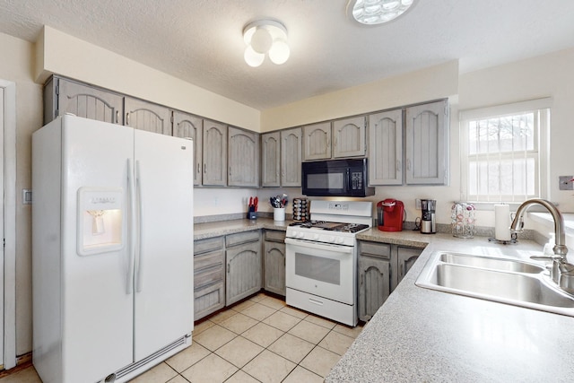 kitchen with gray cabinetry, white appliances, sink, a textured ceiling, and light tile patterned flooring