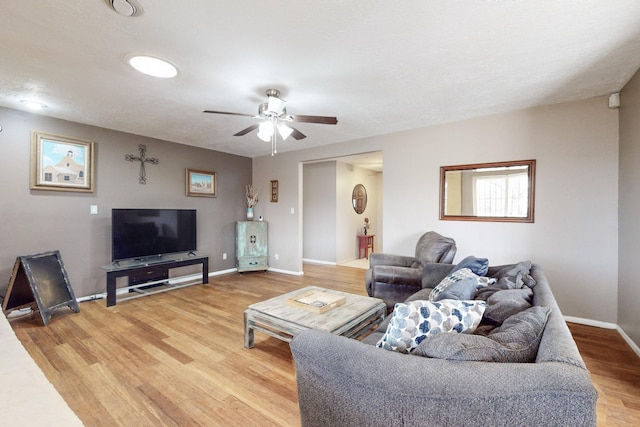 living room with hardwood / wood-style floors and ceiling fan