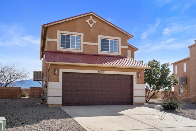 view of front of home with central AC unit and a garage