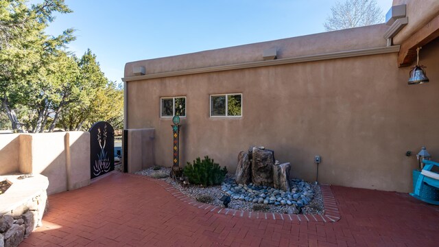2 Chaco Ct, Sandia Park, NM 87047 - view of side of property with a patio and stucco siding