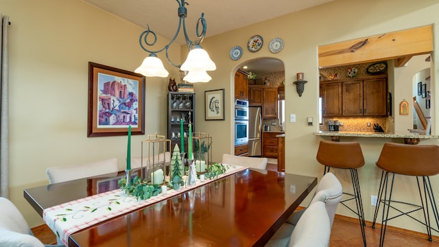 2 Chaco Ct, Sandia Park, NM 87047 - dining area featuring arched walkways and wood finished floors