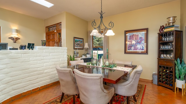2 Chaco Ct, Sandia Park, NM 87047 - dining space with a chandelier and brick floors