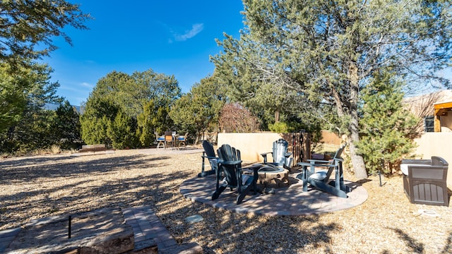 view of yard featuring a patio and a fire pit