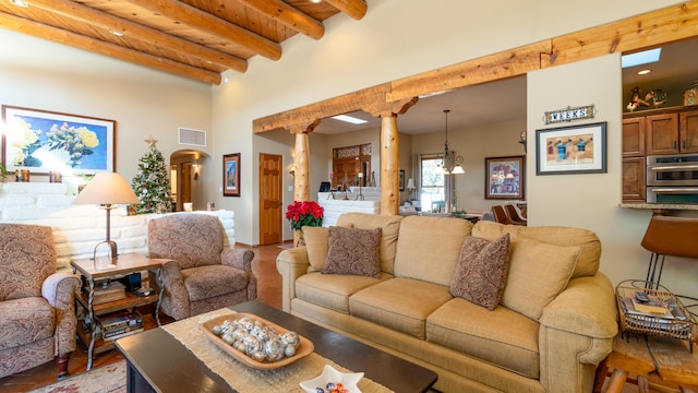 living room with beamed ceiling, ornate columns, and wooden ceiling