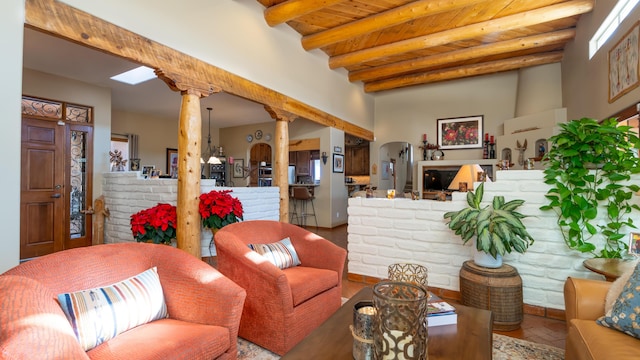 2 Chaco Ct, Sandia Park, NM 87047 - living area with a wooden ceiling with exposed beams, decorative columns, and arched walkways