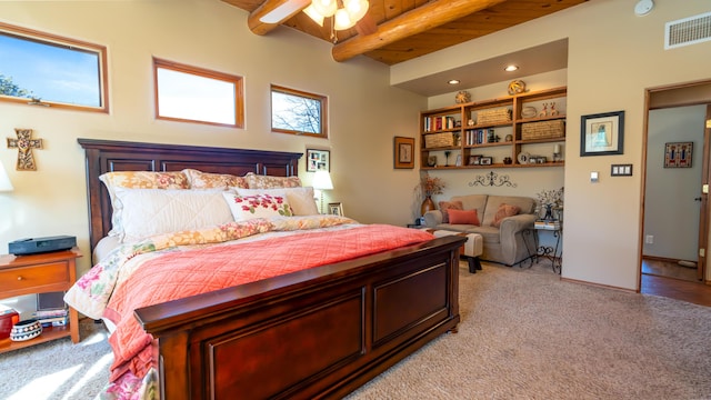 carpeted bedroom featuring beam ceiling, ceiling fan, and wood ceiling