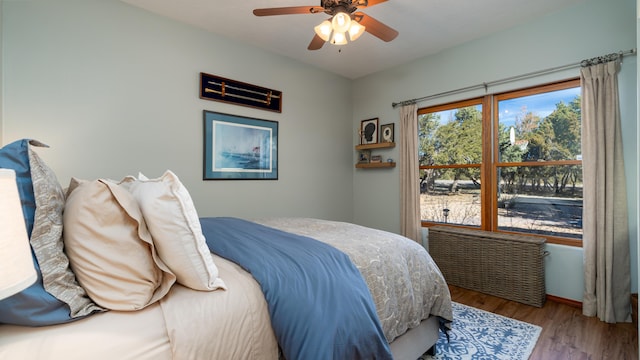 2 Chaco Ct, Sandia Park, NM 87047 - bedroom featuring wood finished floors, radiator heating unit, and a ceiling fan