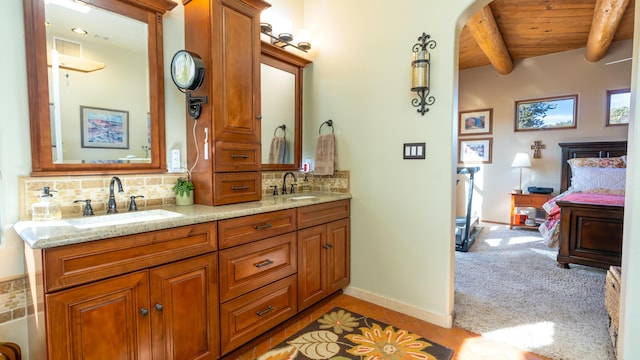 bathroom featuring beamed ceiling, vanity, wood ceiling, and backsplash