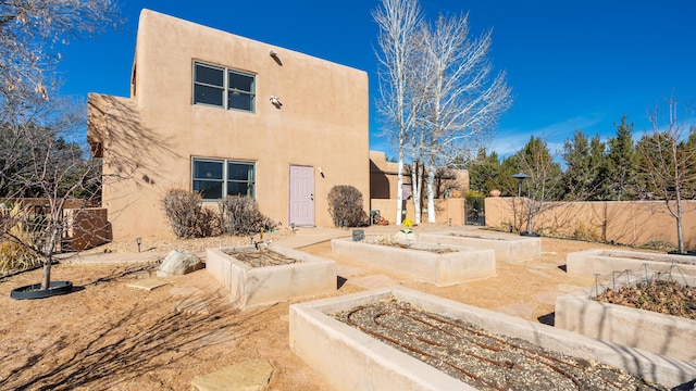 2 Chaco Ct, Sandia Park, NM 87047 - rear view of house featuring a garden and stucco siding