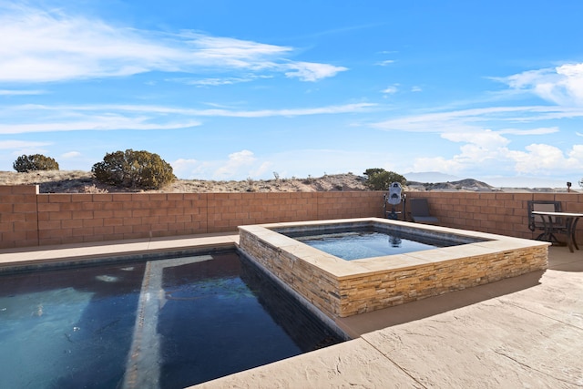 view of swimming pool featuring an in ground hot tub, a fenced backyard, and a fenced in pool