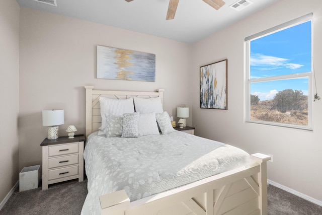 bedroom featuring visible vents, dark carpet, baseboards, and ceiling fan