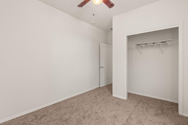 unfurnished bedroom featuring light carpet, a closet, and ceiling fan