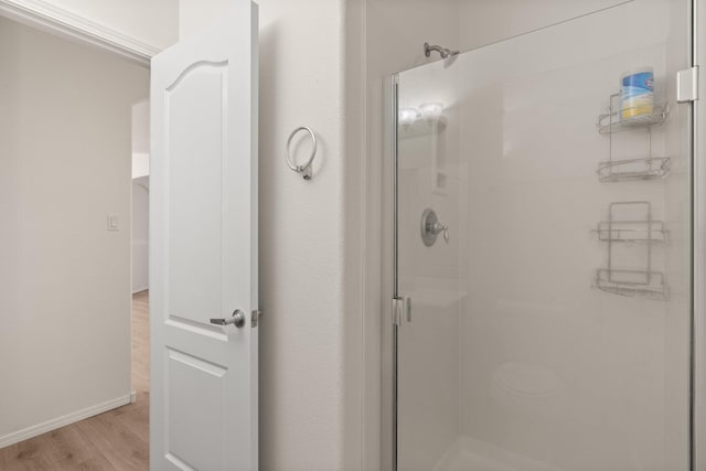 bathroom featuring an enclosed shower and hardwood / wood-style floors