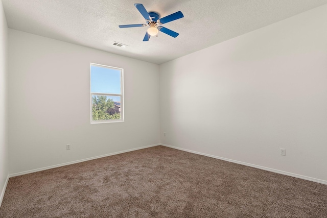 carpeted spare room with ceiling fan and a textured ceiling