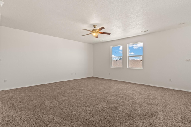 empty room with ceiling fan, carpet flooring, and a textured ceiling