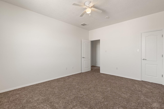 unfurnished bedroom featuring dark colored carpet, ceiling fan, and a textured ceiling