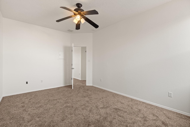 empty room with ceiling fan and carpet flooring