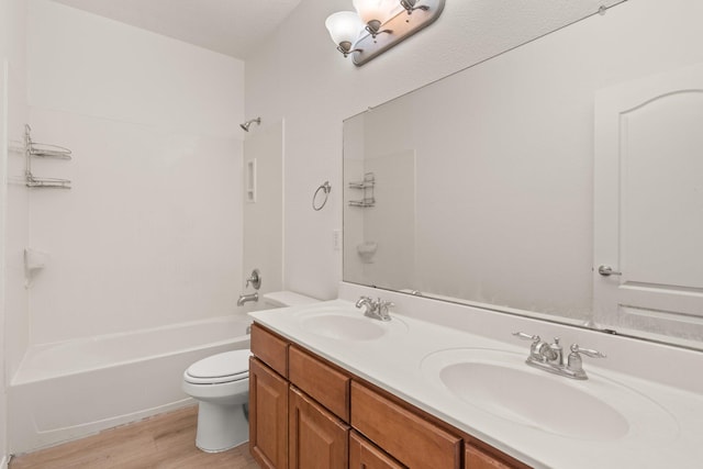 full bathroom featuring vanity, toilet, shower / washtub combination, and hardwood / wood-style floors