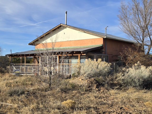 back of house featuring covered porch