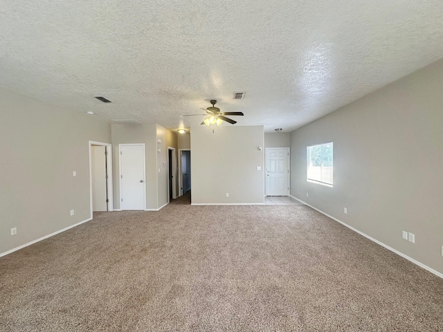 empty room featuring light carpet, a textured ceiling, and ceiling fan