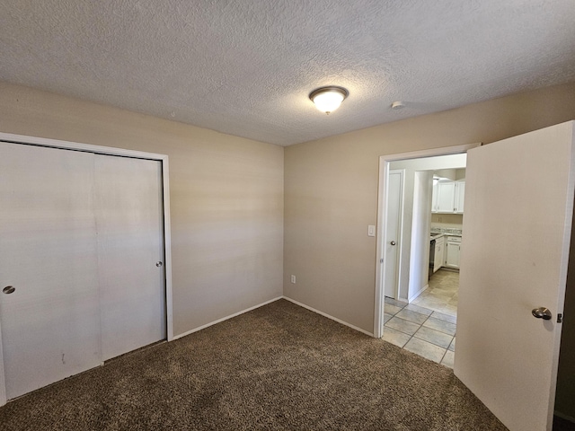 unfurnished bedroom with light carpet and a closet