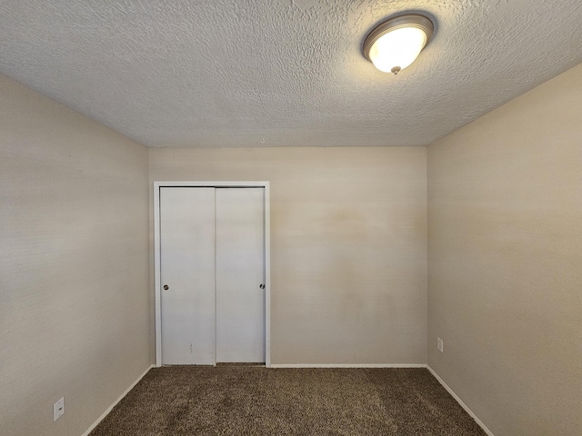 unfurnished bedroom with a closet, carpet, and a textured ceiling