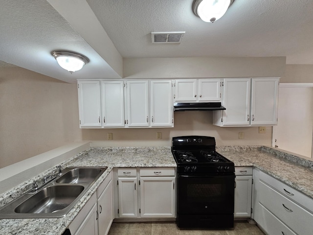 kitchen with gas stove, white cabinetry, sink, and a textured ceiling