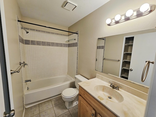 full bathroom featuring tile patterned flooring, vanity, toilet, and tiled shower / bath