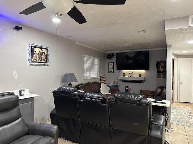 tiled cinema room featuring ornamental molding and a textured ceiling