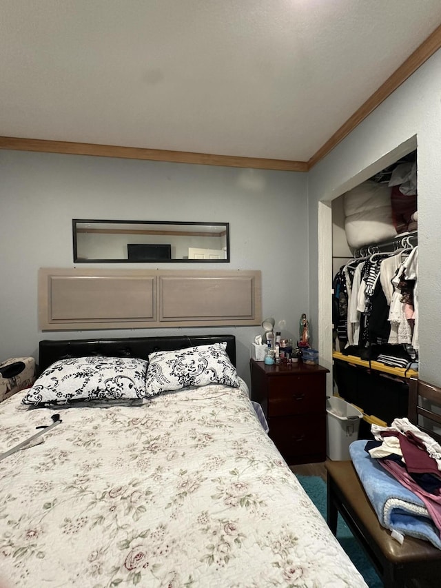 bedroom with crown molding and a closet