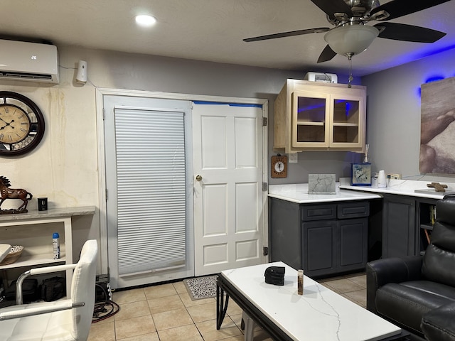 kitchen with a wall mounted air conditioner and light tile patterned floors