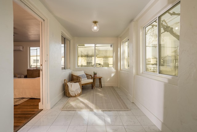 sunroom / solarium featuring a wall mounted air conditioner