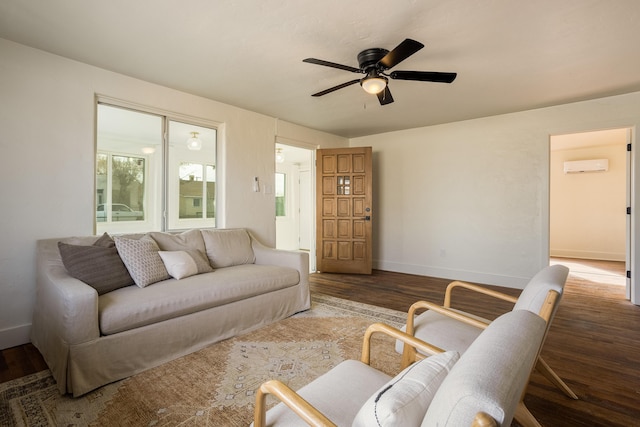 living room with ceiling fan, wood-type flooring, and an AC wall unit