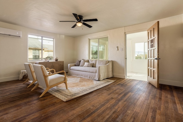 living room with a wall unit AC, ceiling fan, and dark wood-type flooring