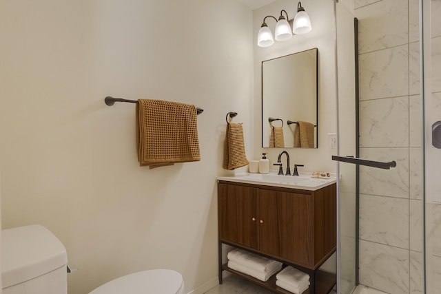 bathroom featuring a tile shower, vanity, and toilet