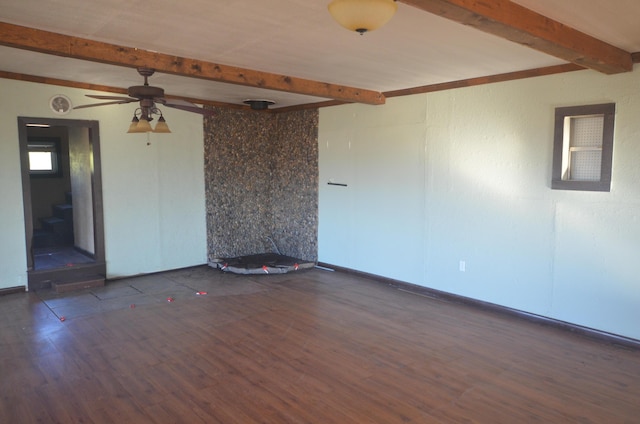 empty room with beamed ceiling, ceiling fan, and dark hardwood / wood-style flooring