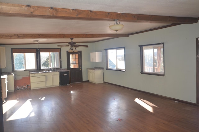 kitchen with beamed ceiling, ceiling fan, black dishwasher, and dark wood-type flooring