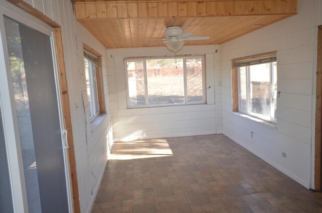 unfurnished sunroom with ceiling fan and wooden ceiling