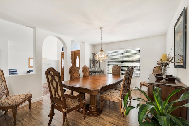 dining space featuring a chandelier and wood-type flooring