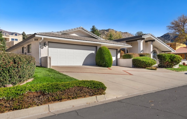 view of front of house with a mountain view and a garage